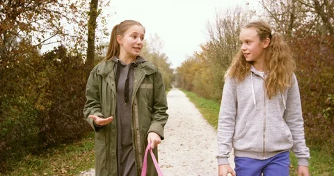 Girls Chatting While Walking In The Park Stock Footage 125038427