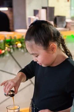 Girls at a culinary workshop on making a refreshing milkshake in a restaurant. Stock Photos