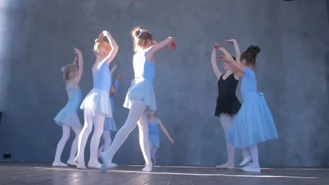 A girls dancer in a ballet school is learning to dance. Little ballerinas in Stock Footage 240975246