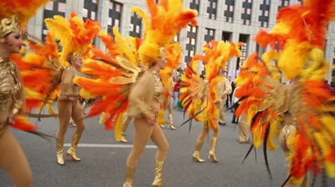Girls dancers dressed in bright feather suits at carnival Video stock 37927770