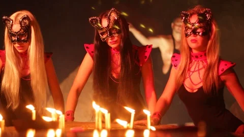 Girls dancing in the light of fire at night in the dark in the old castle Stock Footage 100739730