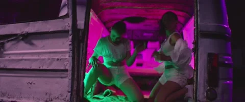 Girls dancing , moving , having fun inside trunk of old abandoned mini bus Stock Footage 158728810