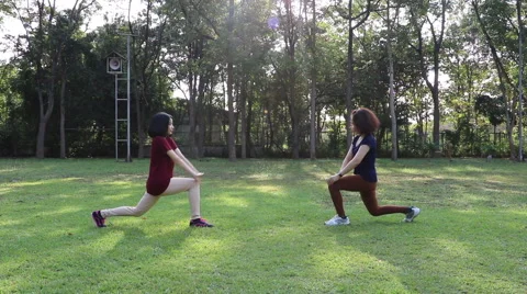 Girls doing exercise in park Stock Footage 58623557