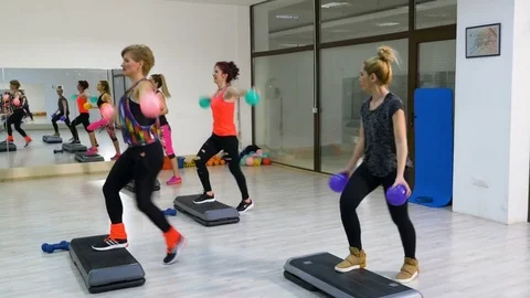 Girls doing Work out with stepper for arms and legs Video stock 73432090