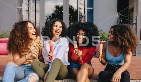 Girls enjoying ice lollies Stock Photos