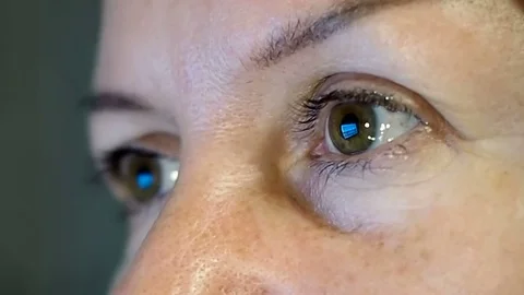 Girl's eyes staring at the blue screen. Stock Footage