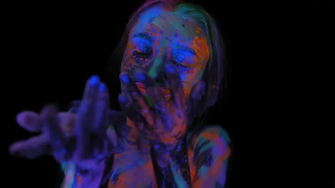 A girl's face with an ultraviolet pattern in the light of a fluorescent lamp. Stock Footage 153489769