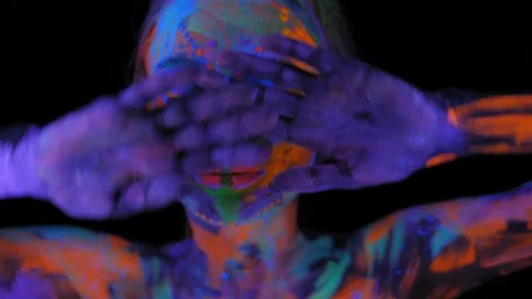 A girl's face with an ultraviolet pattern in the light of a fluorescent lamp. Stock Footage 197014684