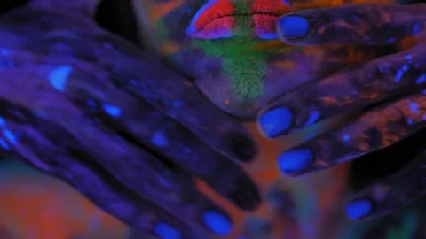 A girl's face with an ultraviolet pattern in the light of a fluorescent lamp. Stock Footage 197348396