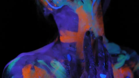 A girl's face with an ultraviolet pattern in the light of a fluorescent lamp. Stock Footage 197465055