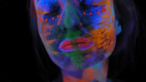 A girl's face with an ultraviolet pattern in the light of a fluorescent lamp. Stock Footage 197465536