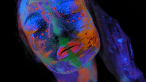 A girl's face with an ultraviolet pattern in the light of a fluorescent lamp. Stock Footage 197642819