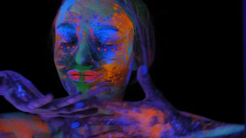 A girl's face with an ultraviolet pattern in the light of a fluorescent lamp. Stock Footage 197839413