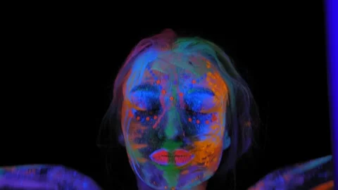 A girl's face with an ultraviolet pattern in the light of a fluorescent lamp. Stock Footage 197851432