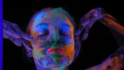 A girl's face with an ultraviolet pattern in the light of a fluorescent lamp. Stock Footage 268789721