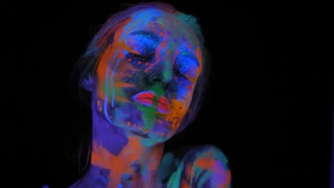 A girl's face with an ultraviolet pattern in the light of a fluorescent lamp. Stock Footage 270061164