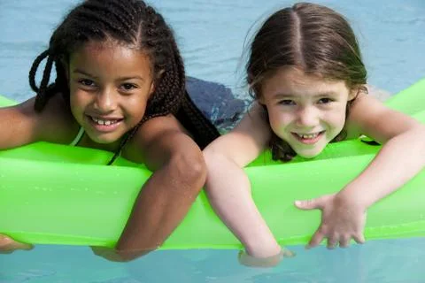 Girls on floatation device Foto stock