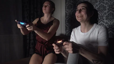 Girls gamble on console, laughs at rival, hit button, common hobby, spend time Stock Footage 119055533