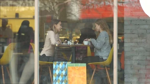Girls with a gift in a cafe. Video stock 82099501