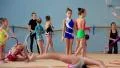 Girls gymnasts having training in gym before examination in Deriugina school HD Footage