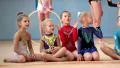Girls gymnasts having training in gym before examination in Deriugina school HD Footage