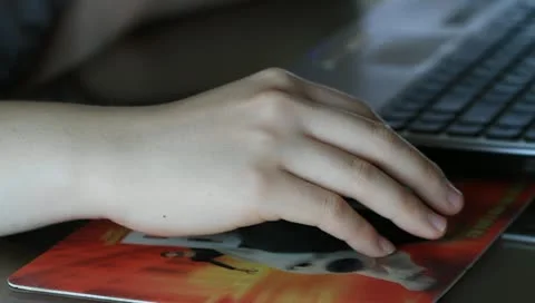 Girl's hand on computer mouse Stock Footage