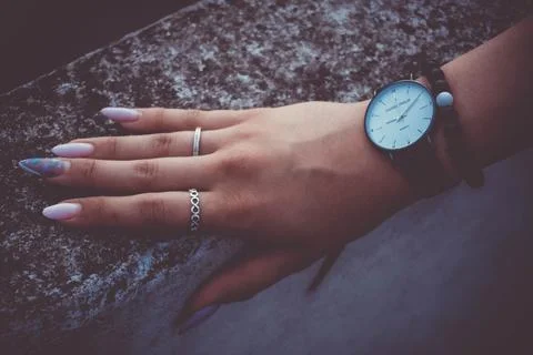 Girls hand with nails and cool watches. Stock Photos