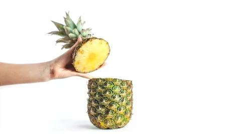 Girl's hand opens the top of a pineapple Stock Footage 62964540