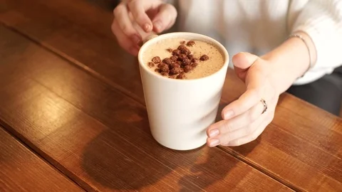 Girl's hand taking a coffee from a table in cafe. Stock Footage 72561853