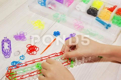 Girl's hand with wristbands and rings made of rubber bands Stock Photos