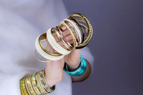 Girl's hands with bracelets Stock Photos
