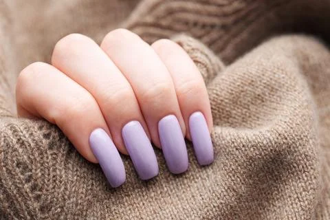 Girl's hands with a soft purple manicure. Stock Photos