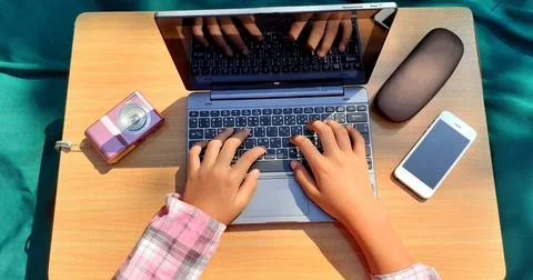 Girl's hands using A laptop, with a smartphone and camera Stock Photos