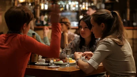 Girls have fun in Cafe Video stock 100239367