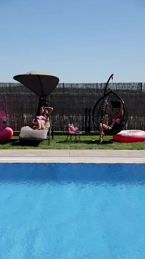 Girls having fun at the poolside Stock Footage 302808512