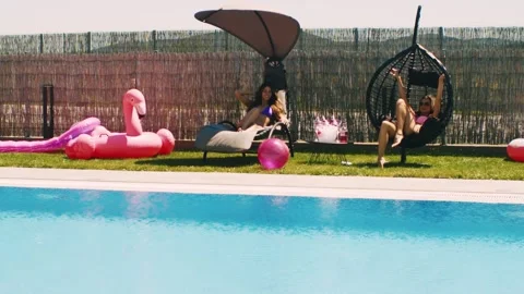 Girls having fun at the poolside. Slow motion. Stock Footage 302805377