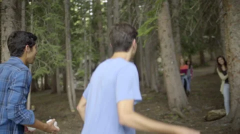 Girls Hide Behind Trees, Their Boyfriends Throw Snowballs At Them In Summer Stock Footage 51889350