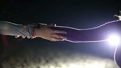 Girls hold hands in the light of colored spotlights Stock Footage 107201685