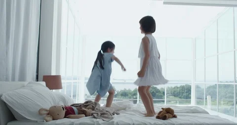 Girls jumping on the bed Stock Footage 100945069
