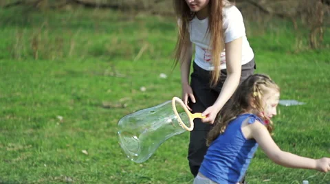 Girls making bubbles in the park Stock Footage 49105036