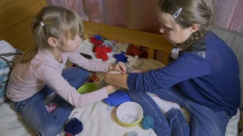 Girls making dolls from strings. Stock Footage 120562486