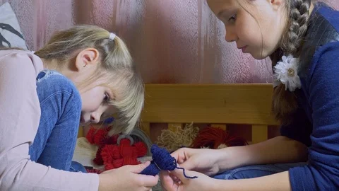 Girls making dolls from strings. Stock Footage 120563301
