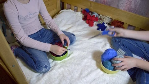 Girls making dolls from strings. Stock Footage 120733821