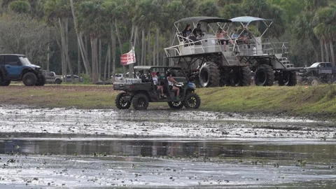 Girls in the mud pit with Side by side car sinking ATV Pink Hair Stock Footage 302326116