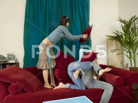 Girls pillow fighing Stock Photos