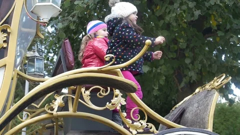 Girls play on a carriage 스톡 동영상 71243477