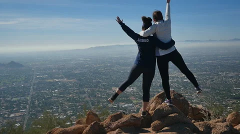 GIRLS POSE ON MOUNTAINTOP Stock Footage 45203809