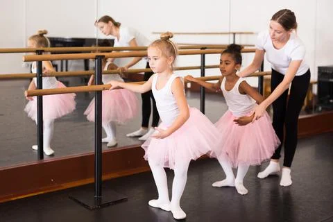 Girls practicing elements on ballet barre Foto stock