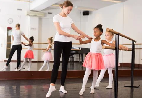 Girls practicing elements on ballet barre 스톡 사진