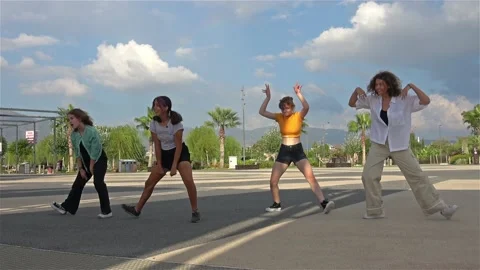 Girls practise dancing in the park Stock Footage 205562317